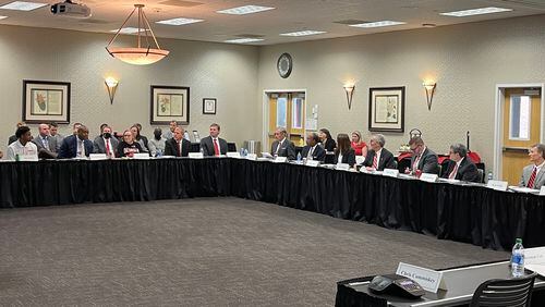 Members of the Georgia Athletic Association's board of directors are called to order by UGA president  and board chairman Jere Morehead (third from right) before a meeting at the Georgia Center for Continuing Education on Wednesday, Feb. 2, 2022. (Photo by Chip Towers/chip.towers@ajc.com)