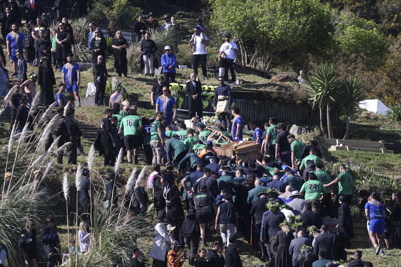 The coffin with the body of New Zealand's Maori King, Kiingi Tuheitia Pootatau Te Wherowhero VII, is carried up Taupiri Mountain for burial in Ngaruawahia, New Zealand, Thursday, Sept. 5, 2024. (AP Photo/Alan Gibson)