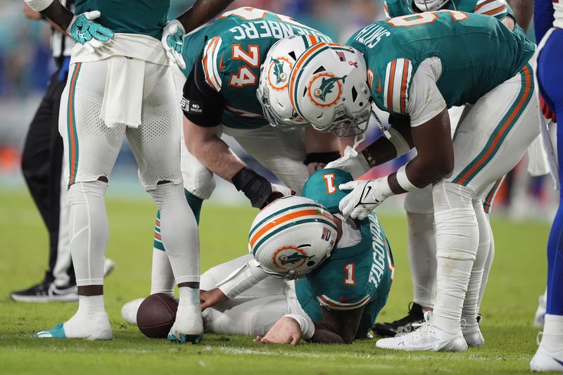 Miami Dolphins quarterback Tua Tagovailoa (1) lies on the field after suffering a concussion during the second half of an NFL football game against the Buffalo Bills, Thursday, Sept. 12, 2024, in Miami Gardens, Fla. (AP Photo/Rebecca Blackwell)