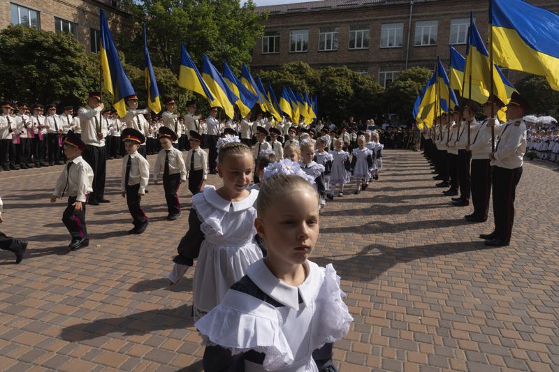 Cadets attend the first day at school in a cadet lyceum in Kyiv, Ukraine, Monday, Sept. 2, 2024. Children and students went to school despite the fact that Kyiv was hit by massive Russian missile barrage early in the morning, causing fires, damaged buildings and infrastructure objects. (AP Photo/Efrem Lukatsky)