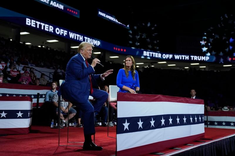 Republican presidential candidate former President Donald Trump, left, on stage with Arkansas Gov. Sarah Huckabee Sanders, right, during a town hall event at the Dort Financial Center, Tuesday, Sept. 17, 2024, in Flint, Mich. (AP Photo/Evan Vucci)