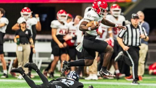 Savannah Christian’s Zo Smalls (4) jumps over a defender on his way to the end zone during the Class 3A GHSA State Championship game at Mercedes-Benz Stadium, on Wednesday, Dec. 13, 2023, in Atlanta. (Jason Allen for the Atlanta Journal Constitution)