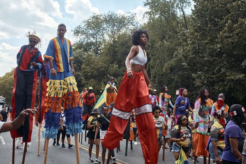 Revelers walk on stilts during the West Indian Day Parade on Monday, Sept. 2, 2024, in the Brooklyn borough of New York. (AP Photo/Andres Kudacki)