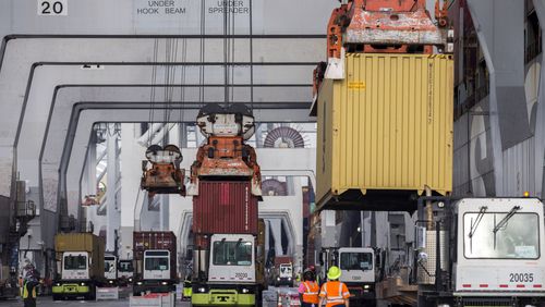 SAVANNAH, GA - DECEMBER 17, 2021: Longshoremen load and unload containers at the Georgia Ports Authority Garden City Terminal. Recently, in coordination with the U.S. Department of Transportation, the Georgia Ports Authority improved its cargo flow by increasing rail capacity and activating flexible "pop-up" container yards near manufacturing and distribution centers. (AJC Photo/Stephen B. Morton)