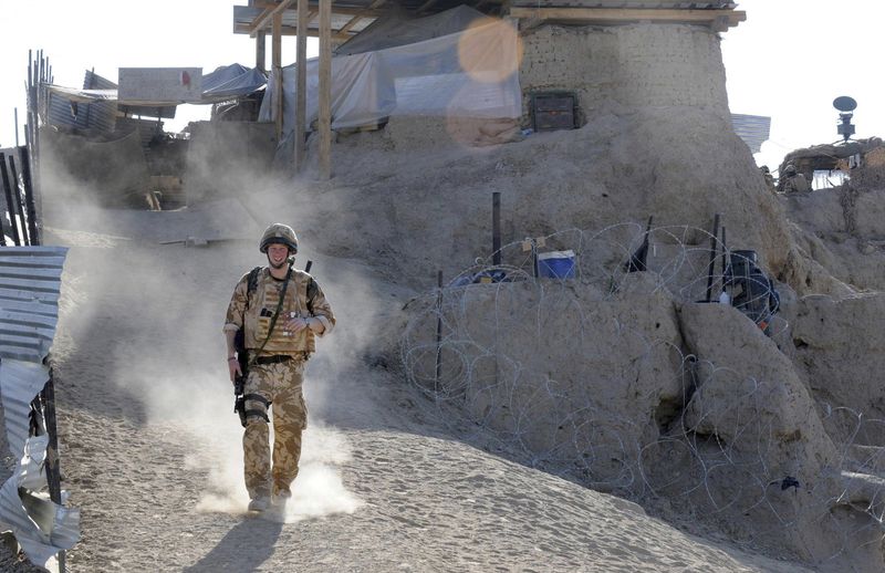 FILE - Britain's Prince Harry on patrol through the deserted town of Garmisir Jan. 2, 2008, close to FOB (forward operating base) Delhi, where he was posted in Helmand province Southern Afghanistan. (John Stillwell, Pool Photo via AP, File)