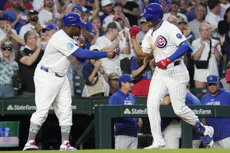 Chicago Cubs' Christopher Morel, right, celebrates with third base coach Willie Harris, left, after hitting a two-run home run during the seventh inning of a baseball game against the New York Mets in Chicago, Sunday, June 23, 2024. (AP Photo/Nam Y. Huh)