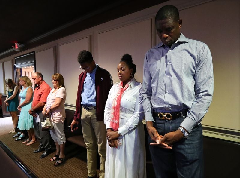 June 11, 2017, Marietta: Dikembe Mutombo, his wife Rose, and son Ryan participate in the closing prayer at Eastside Baptist Church where they have been long time members on Sunday, June 11, 2017, in Marietta.     Curtis Compton/ccompton@ajc.com