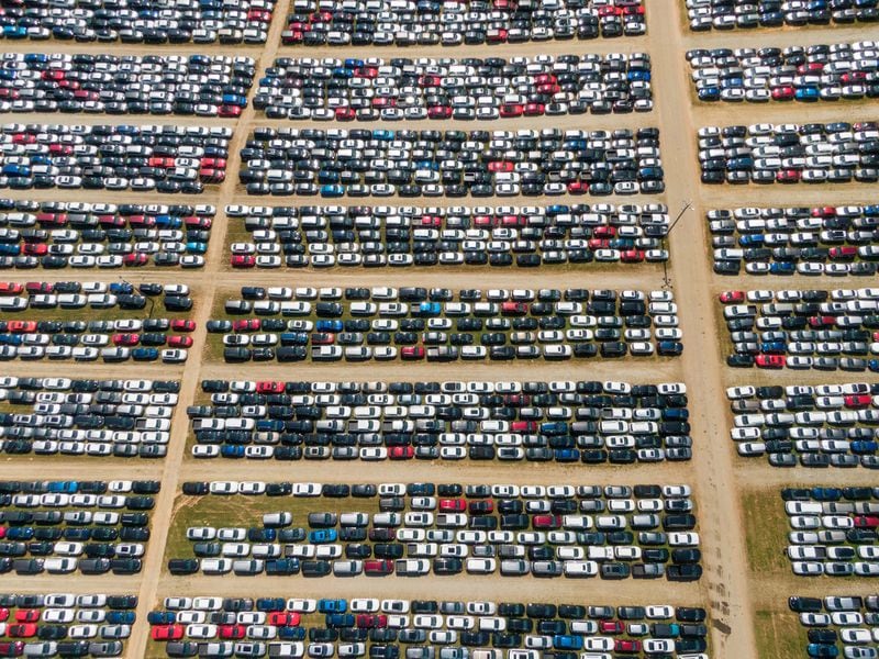 An aerial photo shows thousands of rental cars from Enterprise parked in the lots surrounding the Atlanta Motor Speedway in Hampton on May 12, 2020. The coronavirus has caused rental car demand to plummet so Enterprise sought a place to store its cars. (Hyosub Shin / Hyosub.Shin@ajc.com)