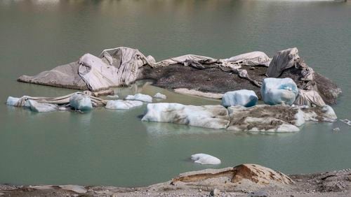 FILE - Chunks of ice float in a lake in front of Rhone Glacier near Goms, Switzerland, June 15, 2023. (AP Photo/Matthias Schrader, File)