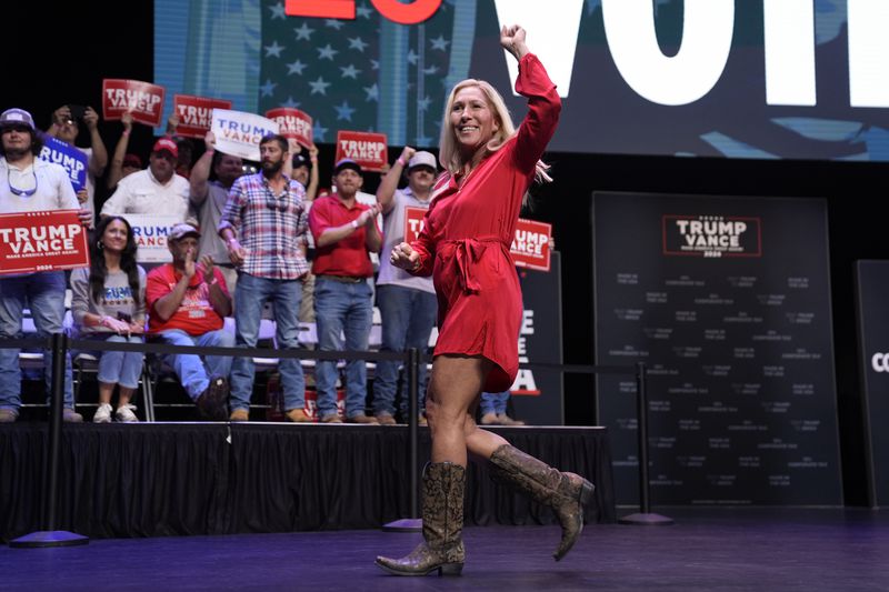 Rep. Marjorie Taylor Greene, R-Ga., walks off after speaking before Republican presidential candidate former President Donald Trump arrives to deliver remarks on the tax code, and manufacturing at the Johnny Mercer Theatre Civic Center, Tuesday, Sept. 24, 2024, in Savannah, Ga. (AP Photo/Evan Vucci)