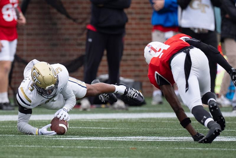 Georgia Tech defensive back Clayton Powell-Lee (5) recovers Virginia Military Institute wide receiver Julio DaSilva's (9) fumble during the first half of a NCAA college football game Sunday, Sept. 14, 2024, in Atlanta,. (AP Photo/John Bazemore)