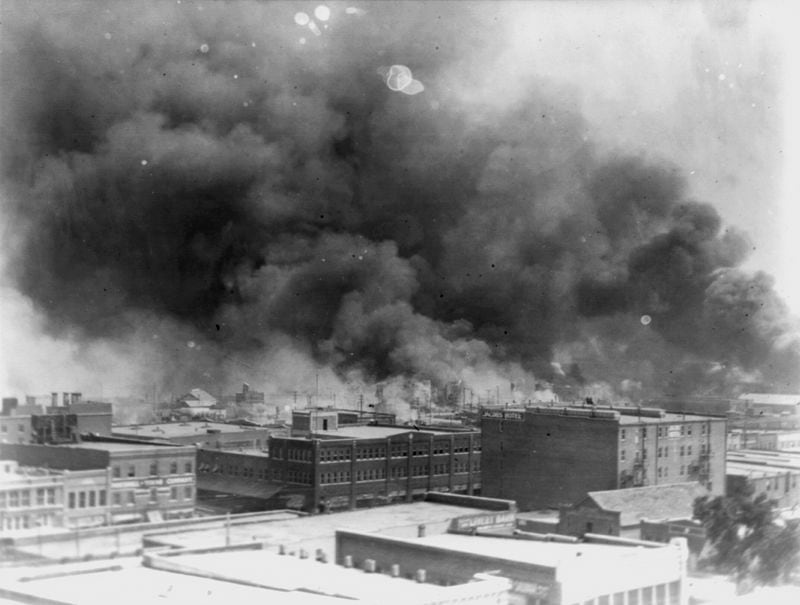 FILE - In this 1921 image provided by the Library of Congress, smoke billows over Tulsa, Okla., during the Tulsa Race Massacre, one of the worst single acts of violence against Black people in U.S. history. Attorneys for the last two remaining survivors of the massacre asked the Oklahoma Supreme court Tuesday, July 2, 2024, to reconsider the case they dismissed last month and called on the Biden administration to help the two women seek justice. (Alvin C. Krupnick Co./Library of Congress via AP, File)