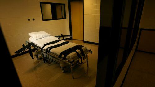 The gurney used for lethal injections sits behind glass windows in a small cinder block building at the Georgia Diagnostic and Classification Prison in Jackson. (Ben Gray / AJC file)