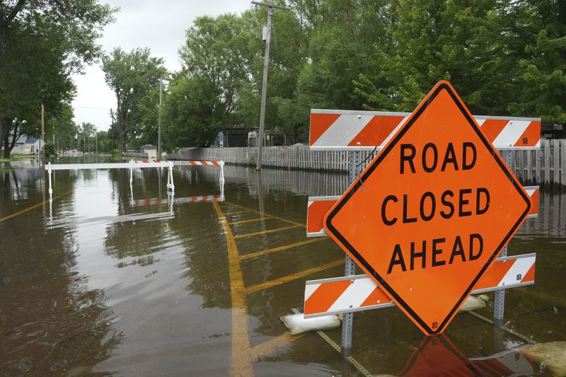 Roads are closed as heavy rains have caused both Tetonka Lake and Sakatah Lake to rise threatening to flood nearby homes and businesses Thursday, June 20, 2024, in Waterville, Minn. (Anthony Souffle/Star Tribune via AP)