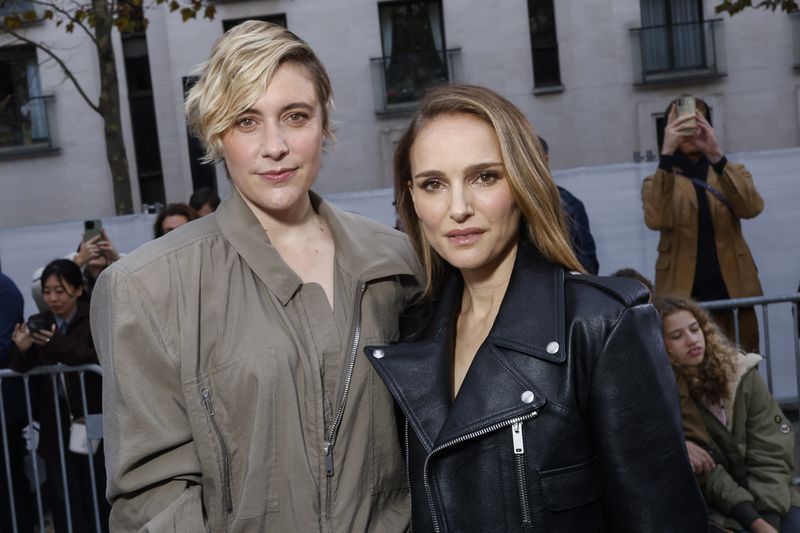 Greta Gerwig, left, and Natalie Portman attend the Stella McCartney Spring/Summer 2025 collection presented Monday, Sept. 30, 2024, in Paris. (Photo by Vianney Le Caer/Invision/AP)