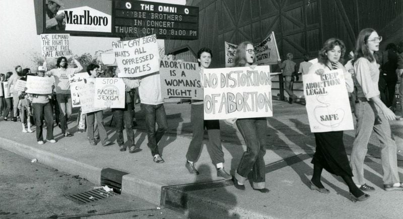 Abortion rights supporters march outside the Omni in 1980 during a Moral Majority convention inside the facility. (Charles R. Pugh, Jr. / AJC archive at GSU Library AJCP178-009c)