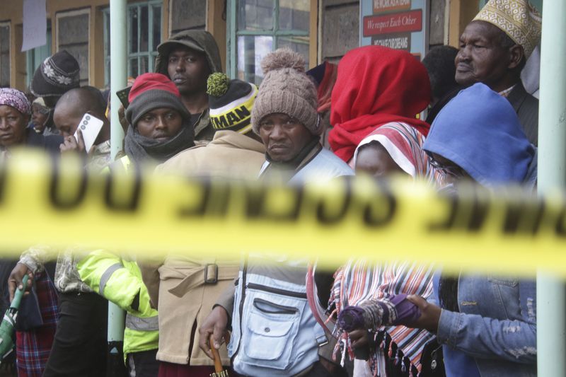 Distressed parents stand near a burnt-out dormitory, following a fire at the Hillside Endarasha Primary in Nyeri, Kenya Friday, Sep. 6, 2024. (AP Photo)