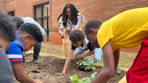 Oakland Elementary students participate in an initiative to plant and grow vegetables at their school’s community garden. (Courtesy of Henry County Schools)