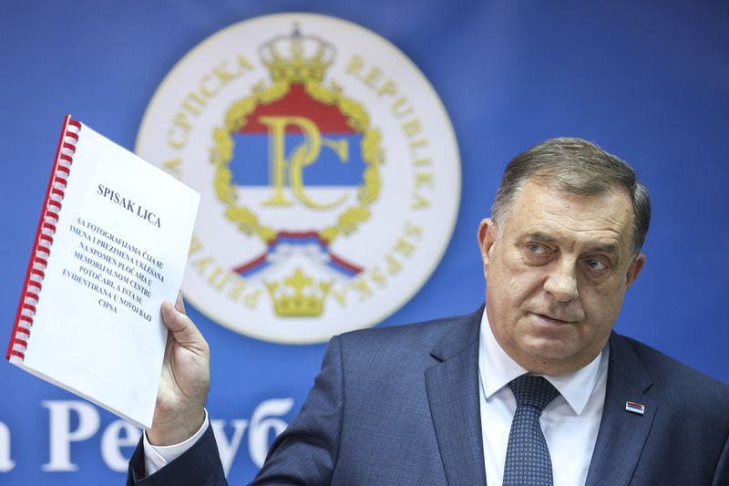 Bosnian Serb political leader Milorad Dodik shows documents during a press conference in Srebrenica, Bosnia, Thursday, May 23, 2024. Today the United Nations General Assembly will be voting on a draft resolution declaring July 11 the International Day of Reflection and Commemoration of the 1995 genocide in Srebrenica. (AP Photo/Armin Durgut)