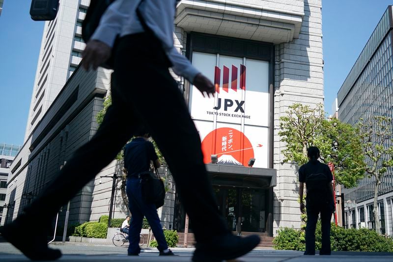 A person walks in front of the Tokyo Stock Exchange building Wednesday, Oct. 2, 2024, in Tokyo. (AP Photo/Eugene Hoshiko)