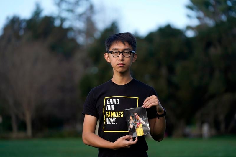 FILE - Harrison Li holds a photo of his father, Kai Li, as he poses for a photo, Jan. 23, 2024, in Palo Alto, Calif. (AP Photo/Jeff Chiu, File)