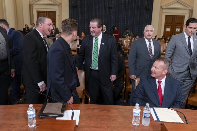 From left, Sgt. Edward Lenz, Commander of Butler County Emergency Services Unit, Patrolman Drew Blasko of Butler Township Police Department, former U.S. Secret Service agent Patrick Sullivan, and Lt. John Herold of Pennsylvania State Police, arrive to testify at the first public hearing of a bipartisan congressional task force investigating the assassination attempts against Republican presidential nominee former President Donald Trump, at Capitol Hill in Washington, Thursday, Sept. 26, 2024. (AP Photo/Ben Curtis)