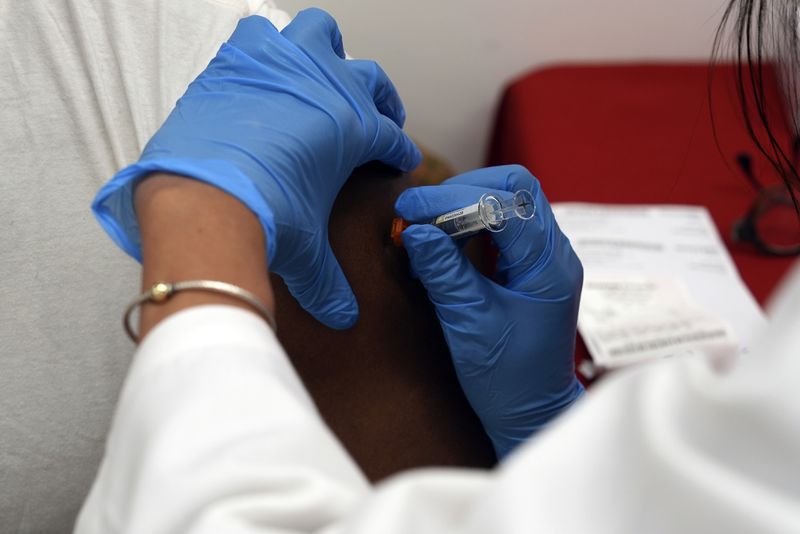 A pharmacist administers a COVID-19 vaccine at a pharmacy in New York, on Tuesday, Sept. 24, 2024. (AP Photo/Mary Conlon)