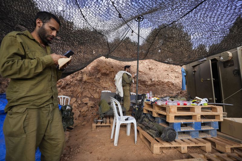 Israeli soldiers pray at a staging area in northern Israel near the Israel-Lebanon border, Tuesday, Oct. 1, 2024. (AP Photo/Baz Ratner)