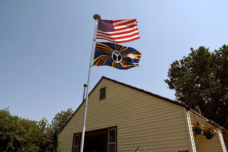 A pride flag flies below the American flag in front of Democrat Becky Blackburn's home in Lusk, Wyo., on July 31, 2024. (AP Photo/Thomas Peipert)