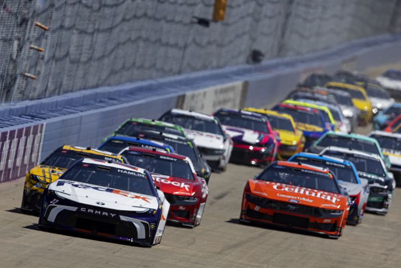 Denny Hamlin (11) leads the field to start a NASCAR Cup Series auto race, Sunday, June 30, 2024, in Gladeville, Tenn. (AP Photo/Wade Payne)