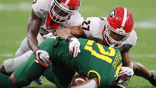 January 1, 2020 New Orleans: Georgia defensive backs Richard LeCounte (left) and Eric Stokes (right) team up to take down Baylor's Josh Fleeks during the Sugar Bowl on January 1, 2020, in New Orleans. Both players are on several 'watch lists' to earn national awards this season. Curtis Compton ccompton@ajc.com