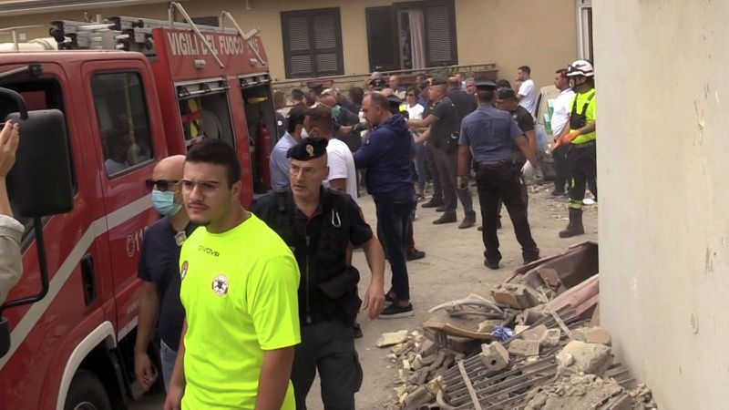 Emergency services attend the site of a building collapse in Saviano, Italy, Sunday Sept, 22, 2024. (LaPresse via AP)