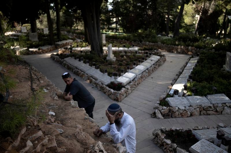 A mourner weeps at the funeral for Israeli Army Capt. Eitan Yitzhak Oster, who was killed in action in Lebanon, at Mt. Herzl military cemetery in Jerusalem, Wednesday, Oct. 2, 2024. (AP Photo/Maya Alleruzzo)