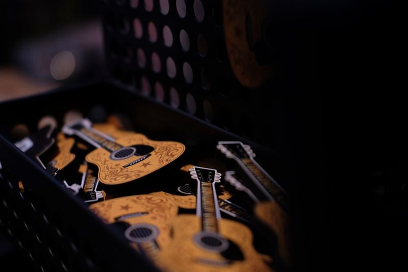 Guitar magnets are displayed at the Ryman Auditorium gift shop in Nashville, Tenn., on July 30, 2024. (AP Photo/Luis Andres Henao)