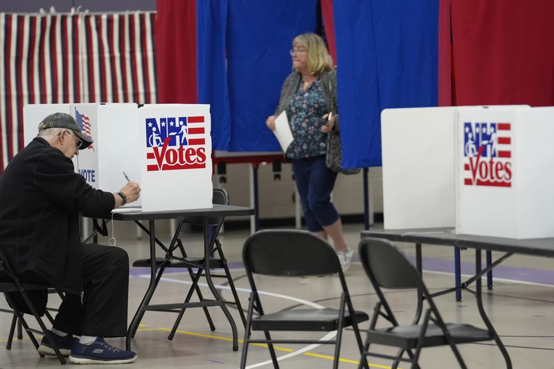 Voters fill out ballots, in a primary election to pick candidates for governor, the U.S. House, and the state Legislature, Tuesday, Sept. 10, 2024, in Nashua, N.H. (AP Photo/Steven Senne)