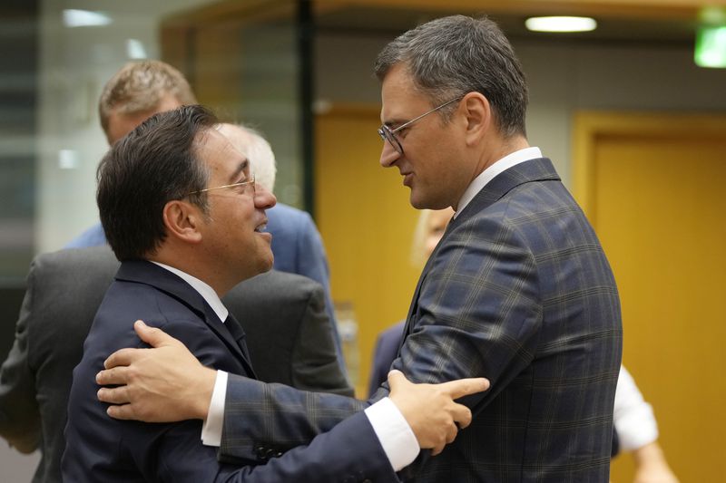 Spain's Foreign Minister Jose Manuel Albares Bueno, left, speaks with Ukraine's Foreign Minister Dmytro Kuleba during a meeting of EU foreign ministers at the European Council building in Brussels, Thursday, Aug. 29, 2024. (AP Photo/Virginia Mayo)