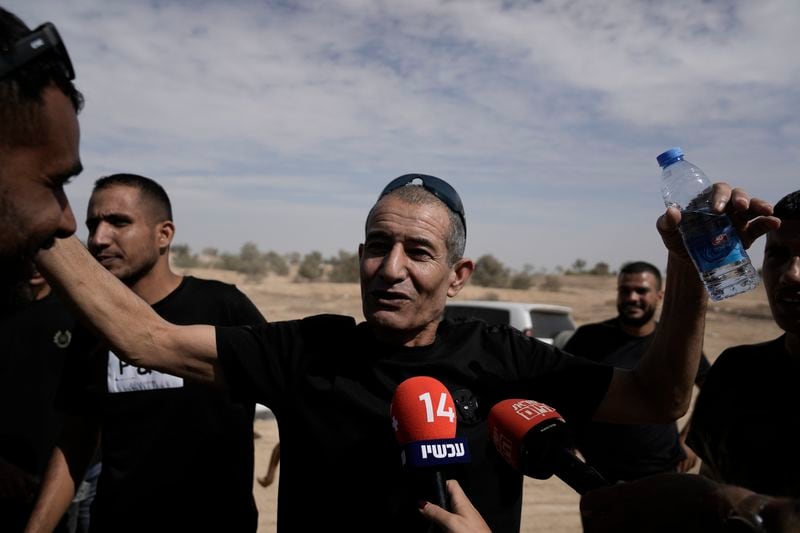 Qaid Farhan Alkadi, 52, who was held hostage by Hamas militants in Gaza Strip, meets his relatives and friends after arriving in the Khirbet Karkur village, near of Rahat, southern Israel, Wednesday, Aug. 28, 2024. (AP Photo/Mahmoud Illean)