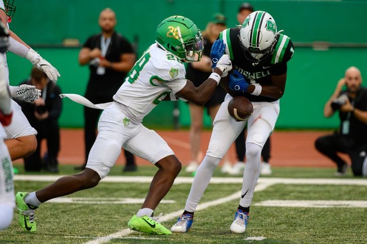 Buford’s Jameer Cantrell causes a Roswell fumble. (Jamie Spaar for the Atlanta Journal Constitution)