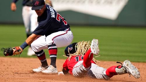 The Braves' Luke Waddell (left) tries to apply a tag on Boston's Tapia Raimel during a 2023 spring game. (AP Photo/Brynn Anderson)