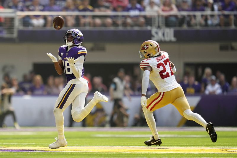 Minnesota Vikings wide receiver Justin Jefferson (18) catches a 97-yard touchdown pass over San Francisco 49ers safety Ji'Ayir Brown (27) during the first half of an NFL football game, Sunday, Sept. 15, 2024, in Minneapolis. (AP Photo/Abbie Parr)