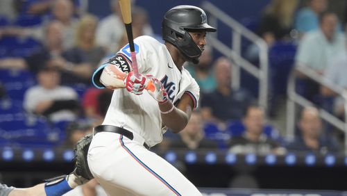 Miami Marlins' Jesús Sánchez (12) hits a single during the first inning of a baseball game against the Los Angeles Dodgers, Tuesday, Sept. 17, 2024, in Miami. (AP Photo/Marta Lavandier)