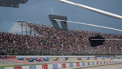 With rain clouds approaching, drivers compete during a NASCAR Cup Series auto race at Michigan International Speedway, Sunday, Aug. 18, 2024, in Brooklyn, Mich. (AP Photo/Carlos Osorio)