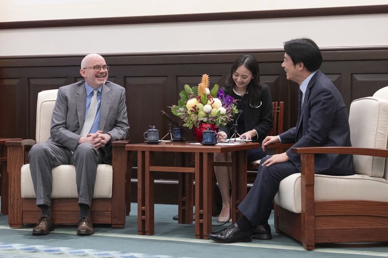 In this photo released by the Taiwan Presidential Office, American Institute in Taiwan's (AIT) director Greene F. Raymond, left speaks with Taiwan's President William Lai Ching-te, in Taipei, Taiwan on July 10, 2024. Raymond who newly assumed his office on July 9, met with Taiwan President William Lai in the morning of July 10, when both reiterated on the strong partnership Taiwan and the U.S. nurtured from the past, with ups and downs. (Taiwan Presidential Office via AP)