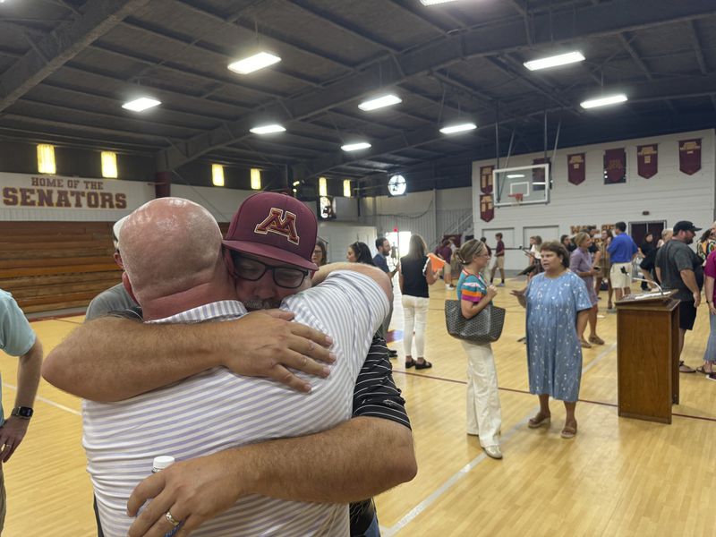 Jamie Tellier, father of Caden Tellier, hugs a student after a memorial service for Tellier's son in Selma, Ala., Monday, Aug. 26, 2024. (AP Photo/Safiyah Riddle)