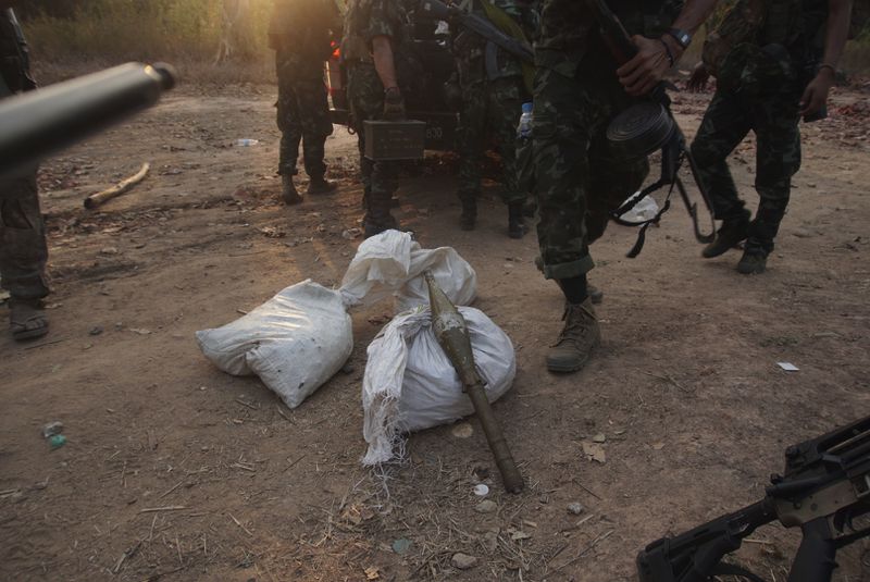 FILE - Members of the Karen National Liberation Army and People's Defense Force collect weapons after they captured an army outpost, in the southern part of Myawaddy township in Kayin state, Myanmar, March 11, 2024. (AP Photo/Metro, File)