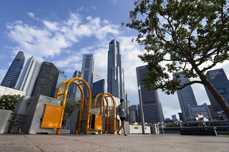 A pedestrian walks along the pavement outside Parliament House, where Pope Francis is scheduled to meet Singapore Prime Minister Lawrence Wong and President Tharman Shanmugaratnam, in Singapore, Saturday, Sept. 7, 2024. (AP Photo/Suhaimi Abdullah)