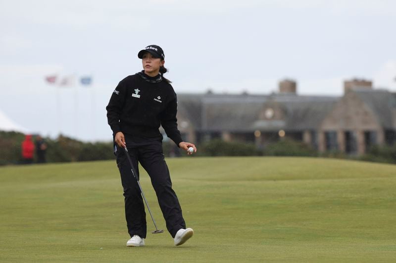 Lydia Ko, of New Zealand, reacts to the crowd after putting on the 16th green during the final round of the Women's British Open golf championship, in St. Andrews, Scotland, Sunday, Aug. 25, 2024. (AP Photo/Scott Heppell)