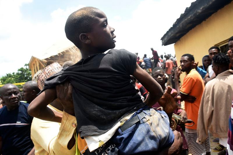 A student is rescued from the rubble of a collapsed two-storey building in Jos, Nigeria, Friday, July, 12, 2024. At least 12 students have been killed after a school building collapsed and trapped them in northern Nigeria, authorities said on Friday. (AP Photos)