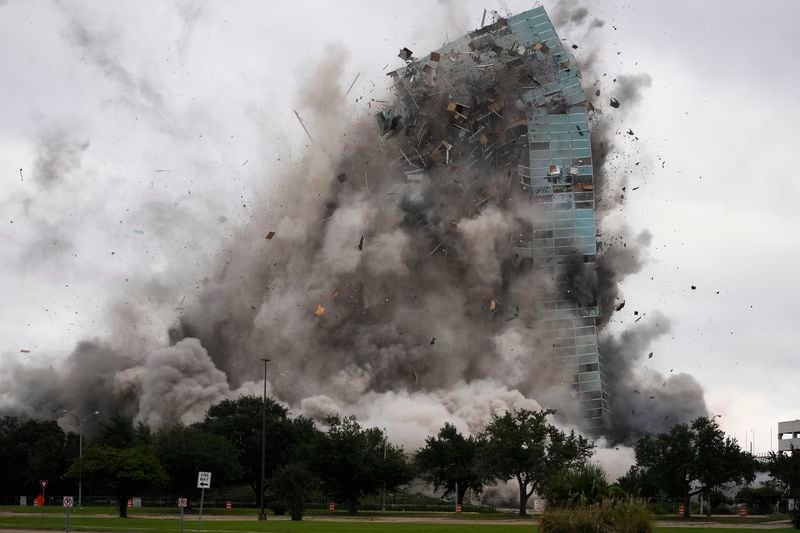 The Hertz Tower, that was heavily damaged after Hurricanes Laura and Delta in 2020, is imploded in Lake Charles, La., Saturday, Sept. 7, 2024. (AP Photo/Gerald Herbert)