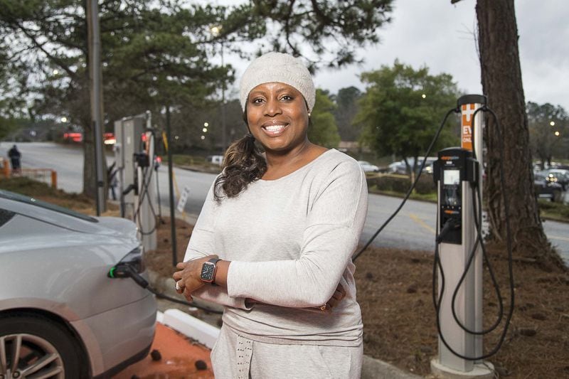 Shelley Francis, co-founder of EVHybridNoire, poses for a photo while charging her electric car near the Hamilton E. Holmes MARTA transit station in Atlanta’s Harland Terrace community on Wednesday, Feb. 5, 2020. ALYSSA POINTER / ALYSSA.POINTER@AJC.COM